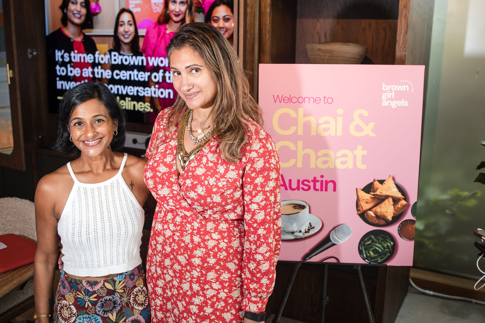 Bhargavi Varma and a guest beside the Chai & Chaat Austin foam-core sign