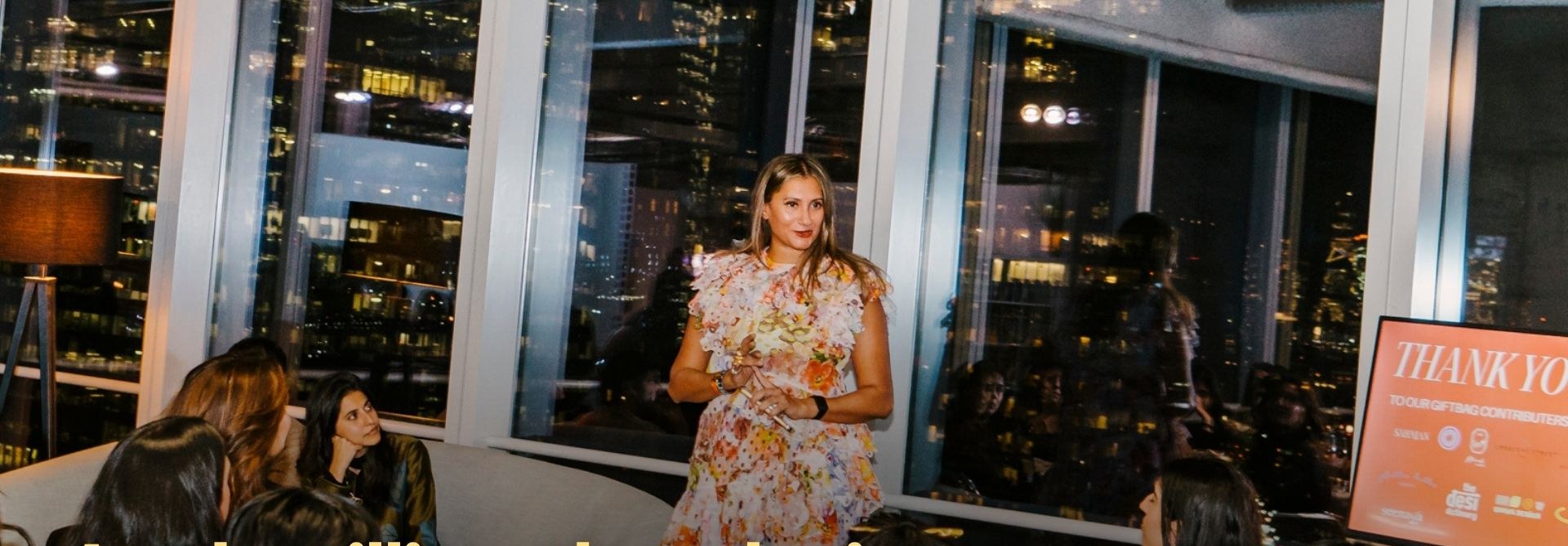 Founder speaking at an evening skyline event — premium experiential gathering